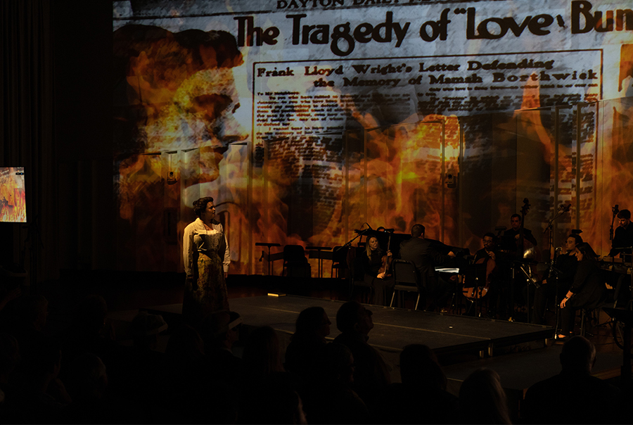 This image is the same scene as seen through the VR goggles. Here, we were able to completely engulf her in flames. You are seeing projections of flames in the background in projections, with assests of flames in the foreground in AR.